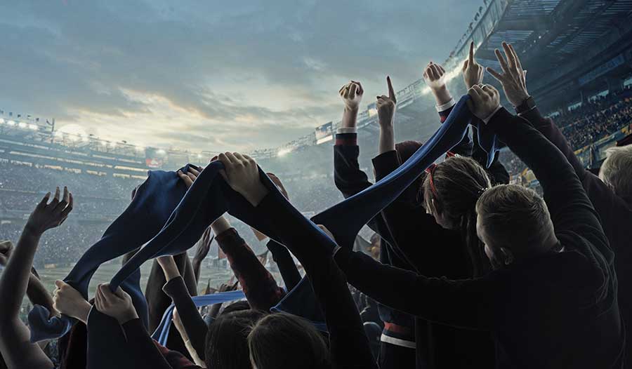 Football fans in packed stadium